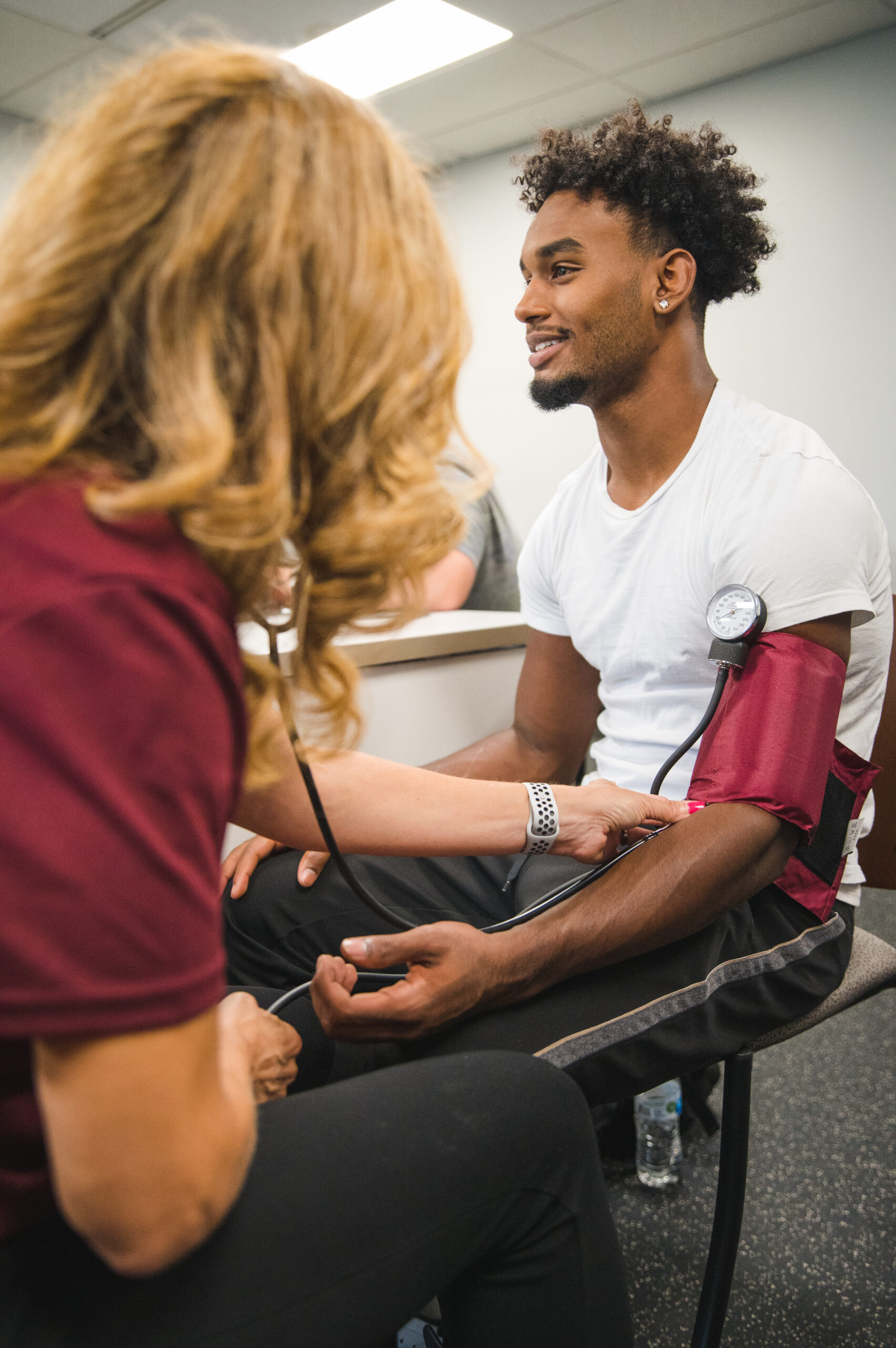 Instructor guiding a student through a blood pressure demonstration.