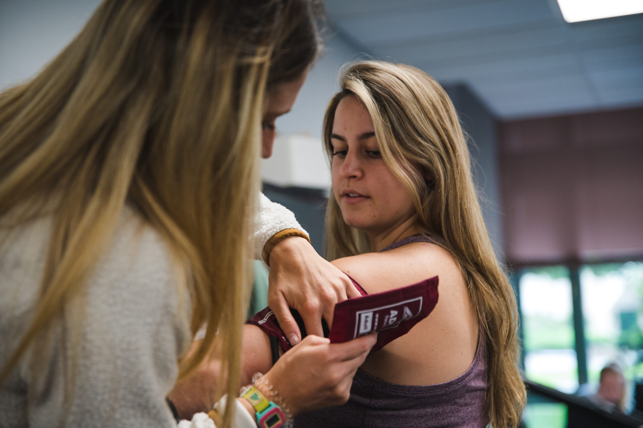 Student practicing measuring blood pressure.