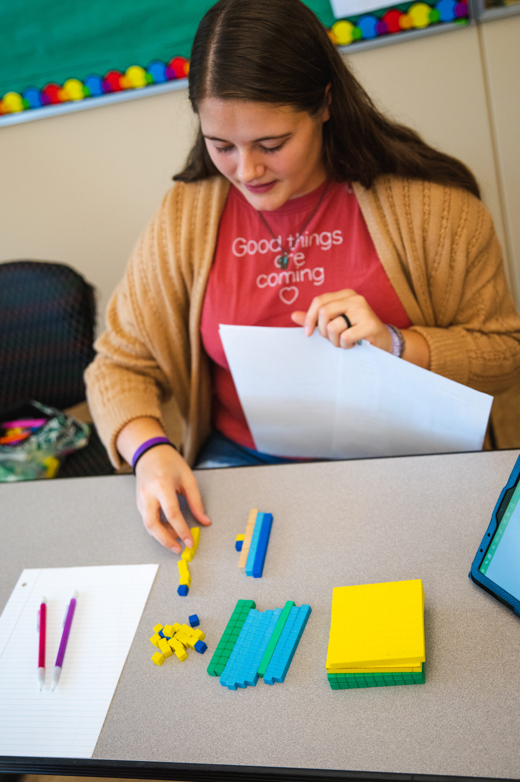 Student preparing classroom materials.