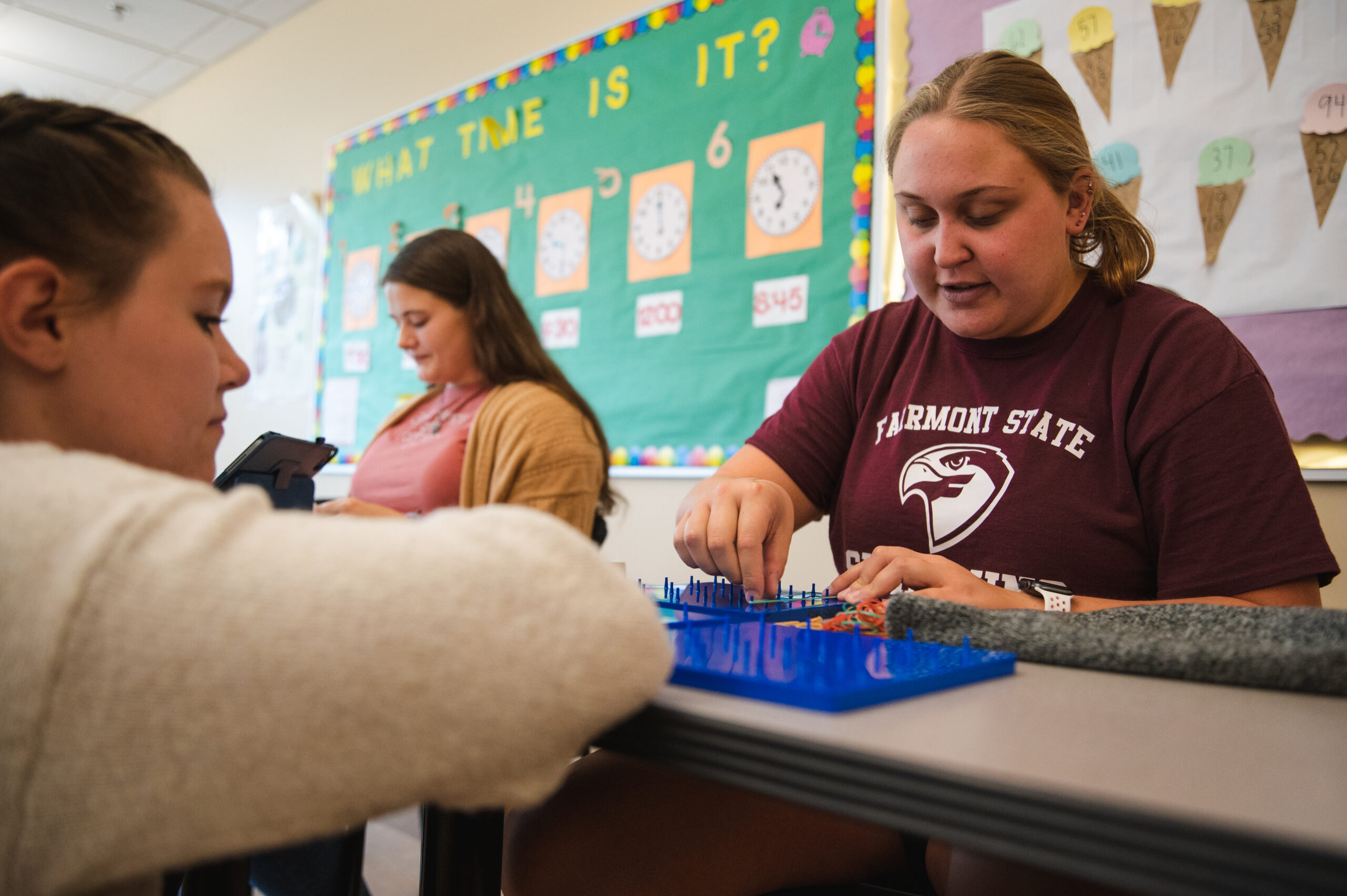Student engaged in hands-on teaching practice.